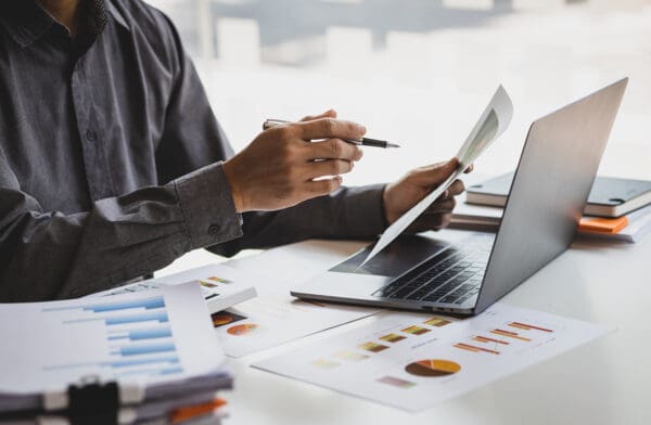 Businessman working with business report papers on office desk